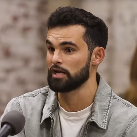 An impassioned young man speaks into the microphone