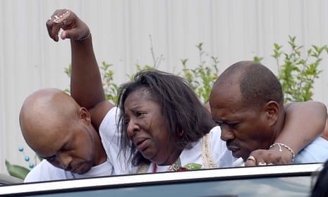 Frances Sanders, mother of Jonathan Sanders, is helped to a waiting car after her son’s funeral service on Saturday at the Family Life church in Quitman, Mississippi.