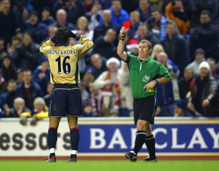 Giovanni van Bronckhorst is shown the red card by referee Paul Durkin on 36 minutes.