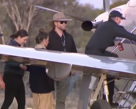 German tourist Carolina Wilga is assisted on to a plane
