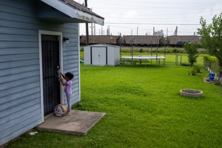 A kid extracurricular her family’s beforehand doorway crossed nan train tracks from nan Motiva refinery.