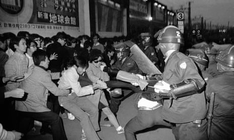 Tokyo riot police attempt to take a student demonstrator into custody in Shinjuku, October 1969.