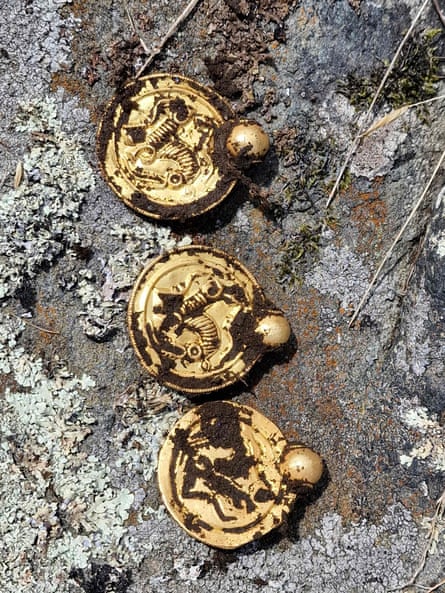 Three coin-like gold pendants that are part of the cache