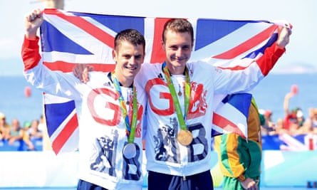 Alistair (right) and Jonny Brownlee hold a union flag with their gold and silver medals around their neck after the men’s triathlon at the Rio Olympics.