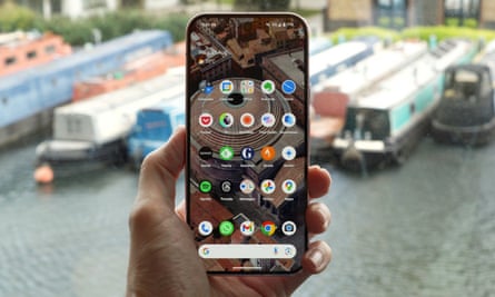 The home screen on the Pixel 9 Pro held in a hand.