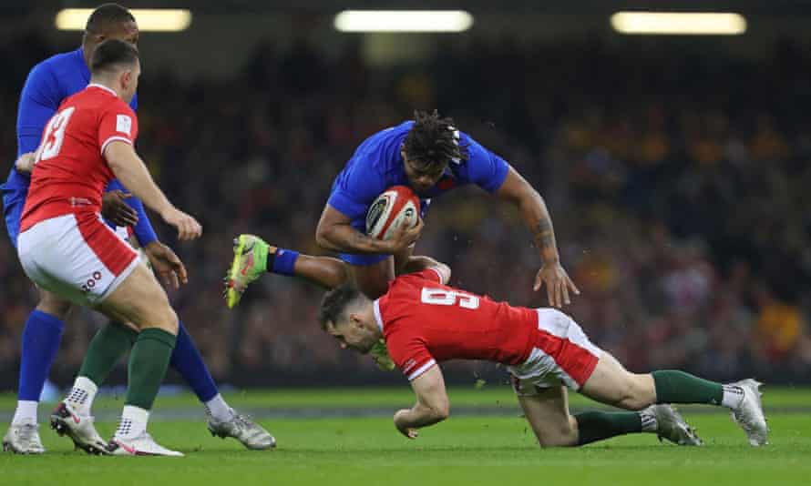 The Wales scrum-half Tomos Williams is injured while attempting to tackle Jonathan Danty of France during the Six Nations.