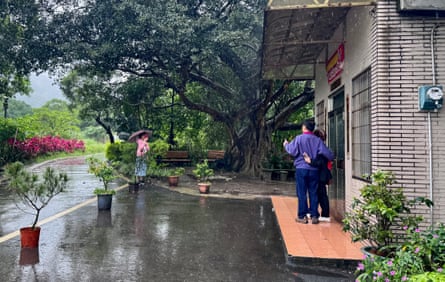Tourists take photos outside a house belonging to Lai Ching-te, in Wanli village.