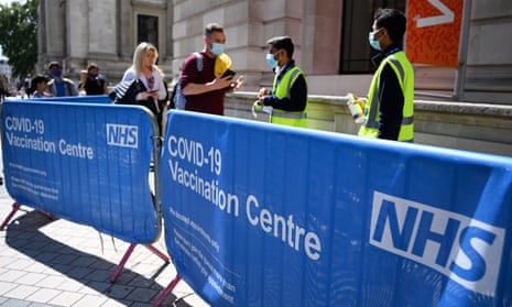 Young people lineup to get vaccinated in London on Friday.