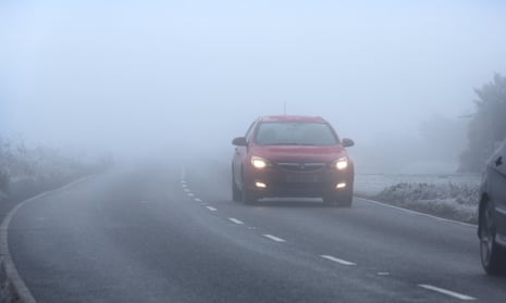 A car driving in dense fog