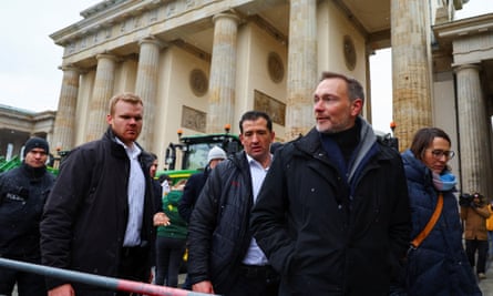 The finance minister Christian Lindner looks on in front of Brandbenburg Gate