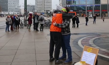 Firas Alshater receives a hug from a stranger.
