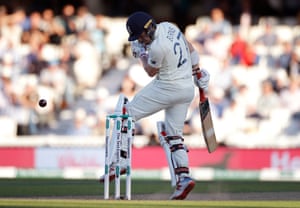 Rory Burns is struck on the helmet by a rising delivery from Pat Cummins.