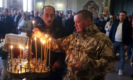 Ukrainian believers light candles at the Cathedral of the Nativity of Christ of the Orthodox Church of Ukraine in Odesa.