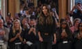 Victoria Beckham accepts applause after her spring/summer 2024 womenswear fashion collection in Paris. 