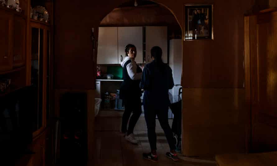 Luisa Vargas (left) in her kitchen where none of the appliances work because she has no light.