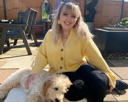 Student Georgia Johnson sitting with a dog.