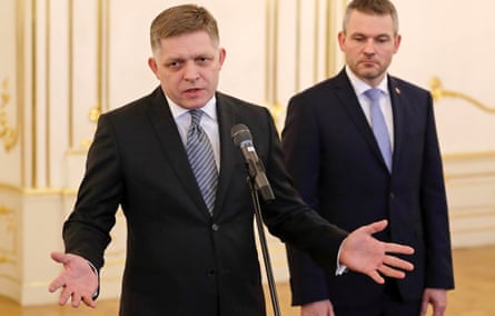Robert Fico speaks after tendering his resignation as his successor Peter Pellegrini looks on in Bratislava in 2018.