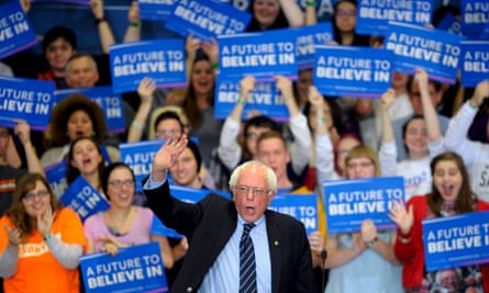 Sanders waves to the crowd as he takes the stage at a campaign rally at Cornell college in Mount Vernon, Iowa.
