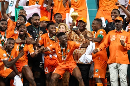 Côte D’Ivoire players celebrate as their country’s president, Alassane Ouattara, lifts the Africa Cup of Nations trophy after they beat Nigeria in the 2024 final