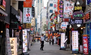 A man walks on a nearly empty street amid tightened social distancing rules in Seoul, South Korea.
