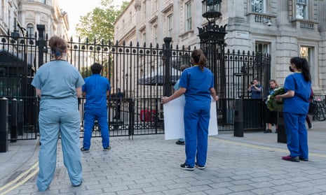 NHS staff staging a silent protest outside Downing Street in May.