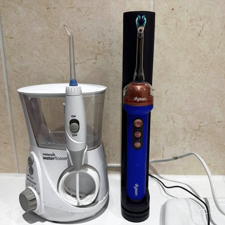 The Dyson CameraJet, with the flosser, the Waterpik Ultra Professional, on the left.