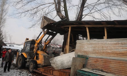 A bulldozer demolishes a shed allegedly built on state land by the owners of Nedous Hotel, on 31 January in Srinagar, India.