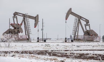 Pump jacks operate in the snow in the Permian Basin in Midland, Texas.