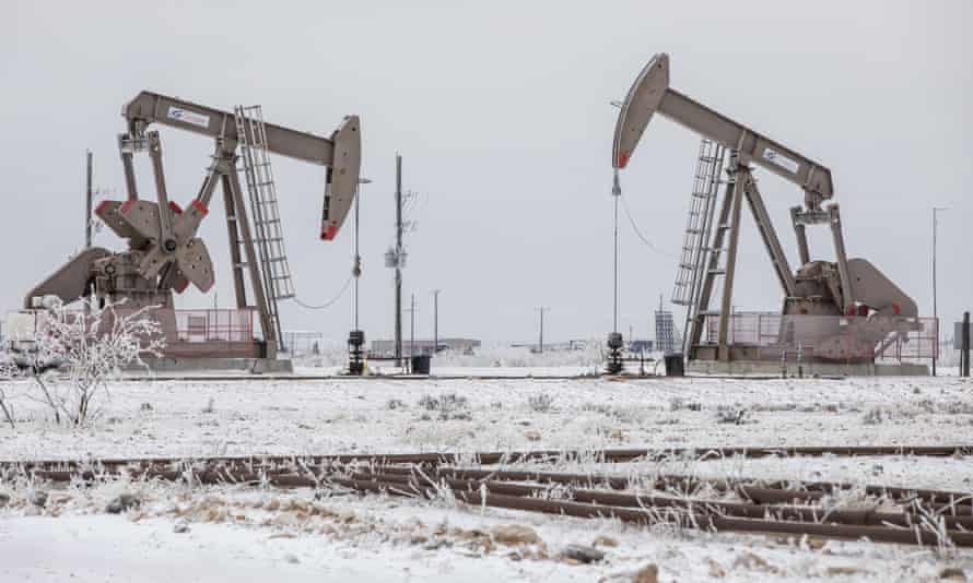Pump jacks operate in the snow in Midland, Texas, in February.