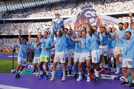 19 May 2024Kyle Walker lifts the Premier League trophy as Manchester City win their fourth straight title following a 3-1 win over West Ham at Etihad Stadium.