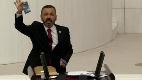 Turkish lawmaker smashes phone with hammer during speech – video