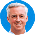 man smiling against blue background