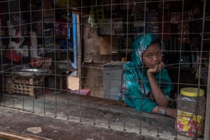 A girl poses inside a shop in the UNHCR refugee camp in Dadaab, Kenya