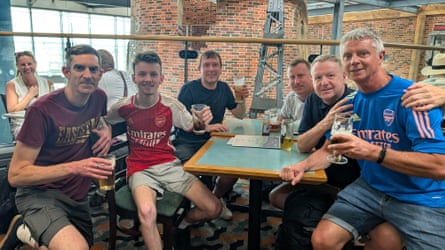 Five men and a boy sitting at a table in a restaurant