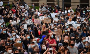 Protestors hold up placards and raise their arms during a “Black Lives Matter†demonstration over the death of George Floyd by a Minneapolis police officer, at Brooklyn Borough Hall on 1 June 2020 in New York.