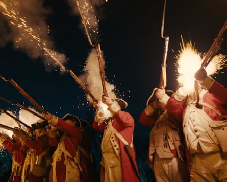 men dressed in uniforms shooting rifles