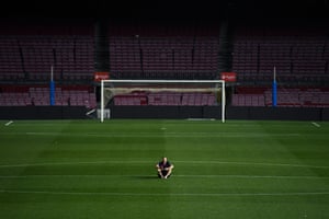 Iniesta sits on the pitch, late after his final Barcelona match.