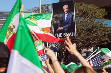 People hold flags and a poster of Reza Pahlavi, the exiled son of Iran's last shah and an Iranian opposition figure, during a rally against Iran's ruling establishment in Los Angeles, California, on Sunday.
