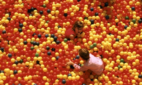 children playing in plastic ball pit