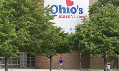 A man walks past Ohio’s Covid-19 mass vaccination clinic at Cleveland State University. The first winner in the state’s Vax-a-Million program was announced.