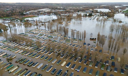 Rows of caravans in deep flood water.