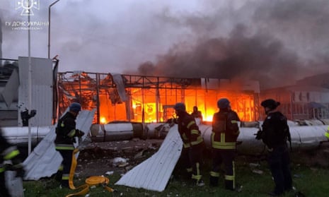 Rescuers extinguishing a fire at the site of a missile strike in Zaporizhzhia.