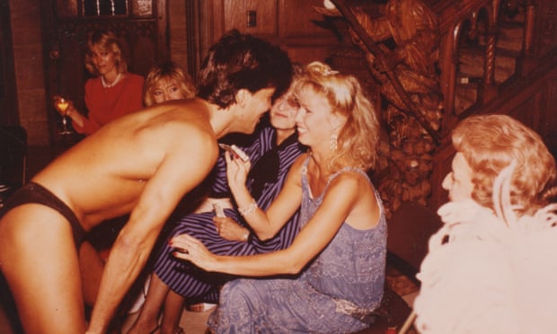 Model Sondra Theodore tips a Chippendale at a bridal shower in the Playboy Mansion.