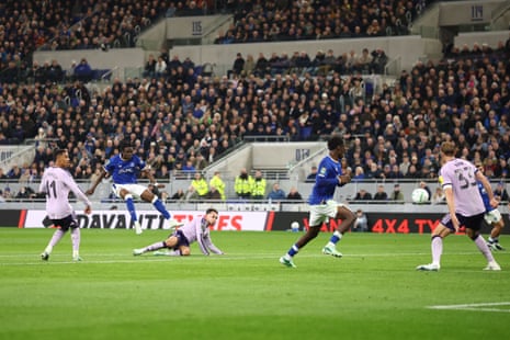 Tyrique George of Everton shoots as opposing players in purple react