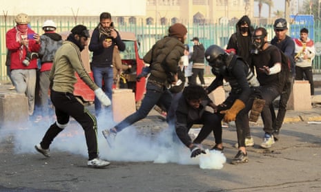 Riot police fire teargas to disperse anti-government protesters in Baghdad, Iraq, on Saturday 25 January.