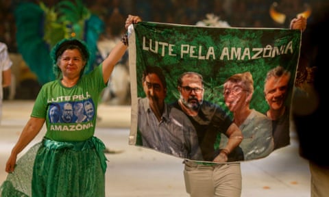 A flag featuring Chico Mendes, Bruno Pereira, Dorothy Stang and Dom Phillips is displayed during the Parintins folk festival in Brazil in June 2022. 