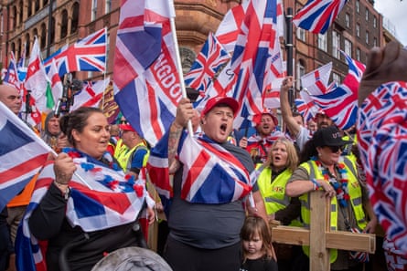 People waving flags at the Unite the Kingdom demonstration in London, September 2025
