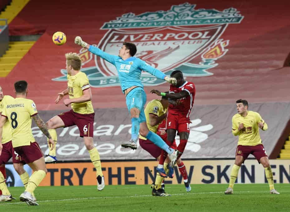 Burnley goalkeeper Nick Pope comes out to punch the ball clear.