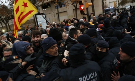 Catalan Mossos d’Esquadra officers scuffle with demonstrators as they cordon off the area around Lleida museum.