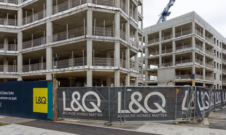 A block of flats being built, ringed with a fence displaying L&Q banners